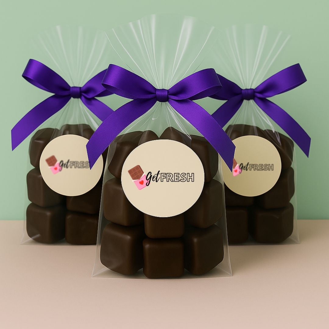 Three gift bags of Get Fresh Chocolates dark chocolate-covered marshmallows, wrapped in clear cellophane with bold purple satin bows and branded round labels—an elegant option for fundraising gifts, events, and holiday treats.