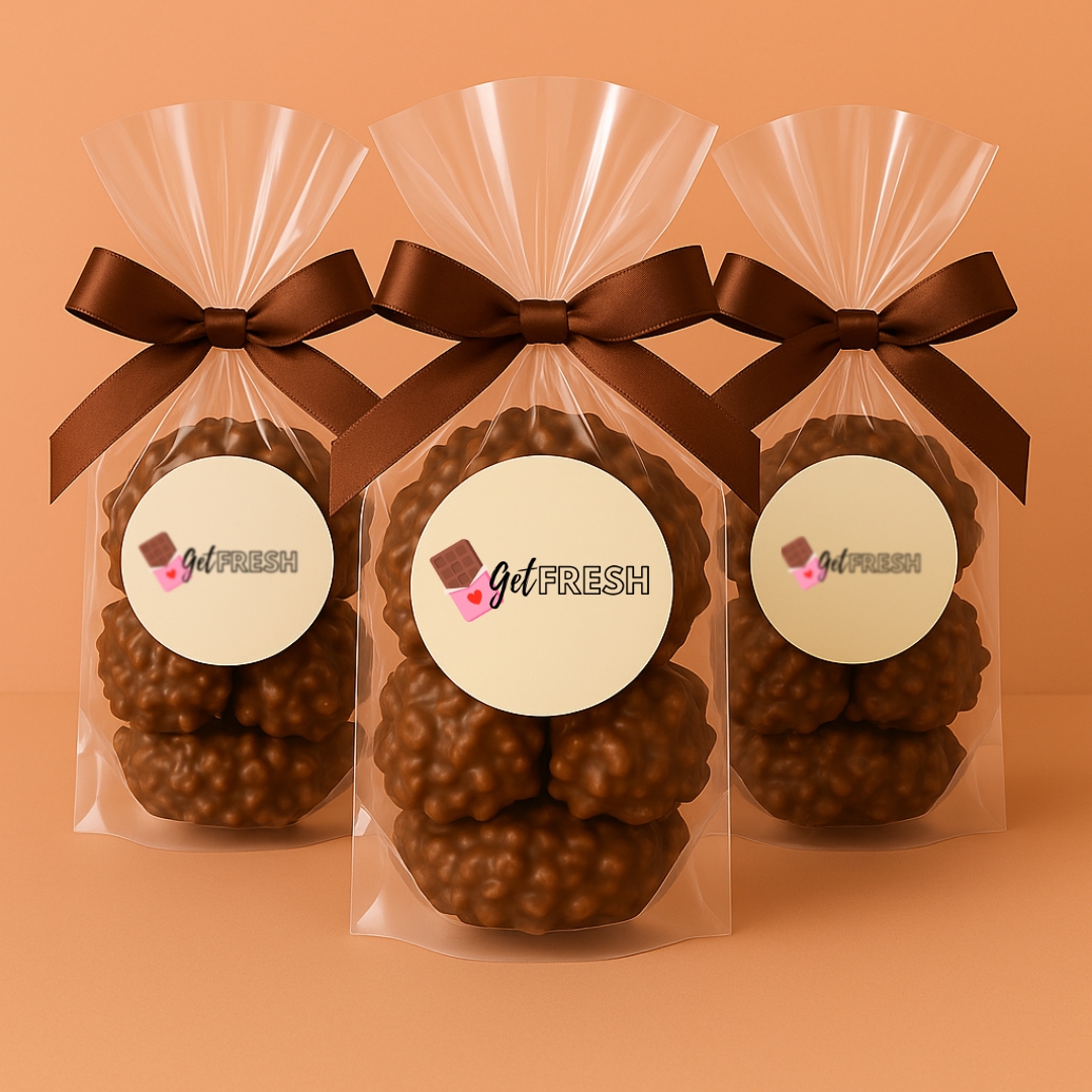 Close-up of GetFresh Milk Chocolate Potato Stick Clusters in a resealable clear bag on a soft peach background — crunchy fries coated in creamy milk chocolate